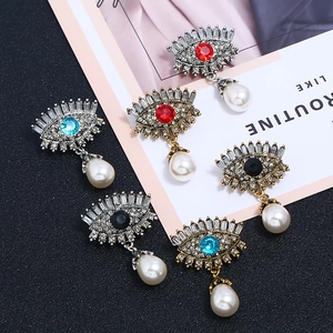 Detail view of Evil Eye drop earrings with crystal rhinestones and waterdrop pearls