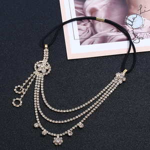 Detail of layered gold flower hair chain with sparkling rhinestones and tassels