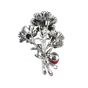 Silver flower brooch back view showing hollow structure, branch stem and pin clasp