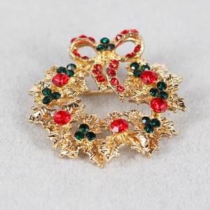 Detailed close-up of a festive Christmas wreath brooch with colorful rhinestones