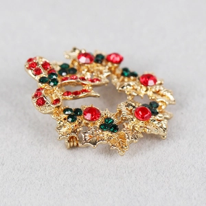 Christmas wreath brooch with red and green rhinestones and a gold-tone bow accent