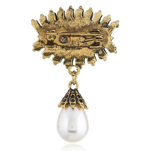 Detailed back view of vintage evil eye brooch with safety pin and white pearl drop