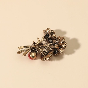 Vintage gold flower brooch with carnation design and red bead detail, back view with pin