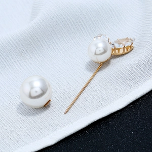 Detailed view of elegant gold pearl brooch pin with marquise-cut crystal accents