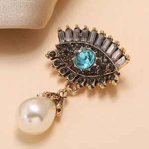 Retro evil eye brooch in antique gold with blue crystal and hanging drop pearl accent