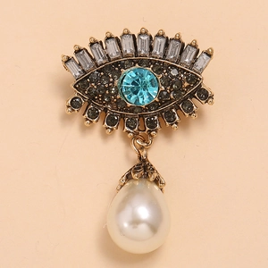 Retro evil eye brooch in gold alloy with blue crystal, rhinestones and pearl drop