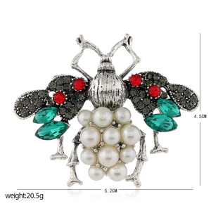 Vintage style bee brooch with colorful crystals and white pearls on silver metal frame