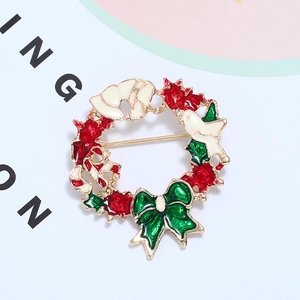 Broche couronne de Noël en métal doré avec baies rouges et nœud vert élégant