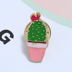 Close-up of enamel cactus brooch with red flower and pink striped pot details