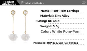 Detail view of long pom-pom earrings featuring white pearls and zinc alloy gold plating