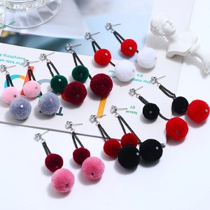 Detail shot of fluffy colorful faux fur pom-pom earrings with cubic zirconia hooks