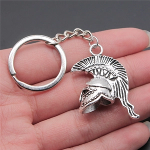 3D vintage Roman Spartan warrior helmet keychain in antique silver finish held by hand