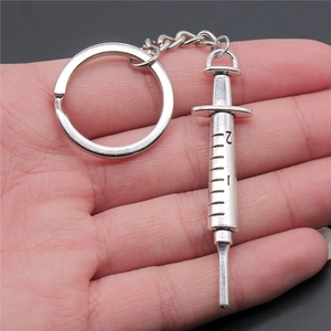 Retro silver metal syringe keychain pendant with detailed scale markings and numbers