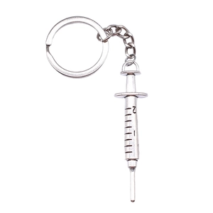 Vintage silver syringe pendant keychain with detailed scale marks for medical gift