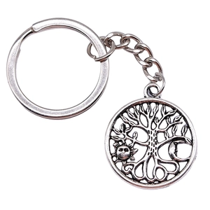 Vintage Tree of Life keychain with celestial sun and moon relief on silver alloy pendant