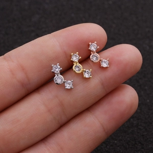 Close-up of curved 925 silver stud earrings with three graduated cubic zirconia stones