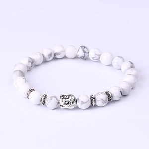 White turquoise energy bracelet featuring a silver Buddha head and ethnic style metal spacers