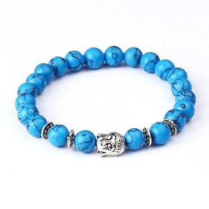 Detailed view of blue turquoise beads and silver buddha head charm on stretch bracelet