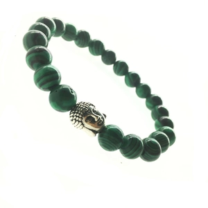 Macro shot of green malachite beads and silver Buddha head on a beaded bracelet