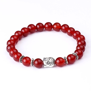 Detail of red agate beads bracelet with a silver Buddha head charm and vintage spacers