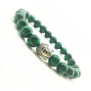Green malachite beaded bracelet with silver Buddha head charm on white background