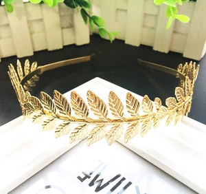 Detail of a golden laurel leaf headband with intricate Greek style metallic textures