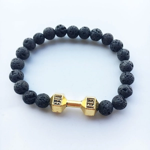 Detailed close-up of black lava stone beads and golden dumbbell charm with LIFE FIT text