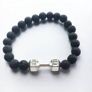 Fitness themed bracelet featuring black volcanic stone beads and silver dumbbell charm