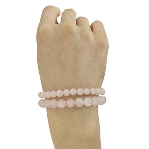Detailed view of dual-strand pink crystal bead bracelets on a female wrist accessory