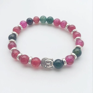 Macro shot of colorful volcanic lava beads and silver Buddha head on an elastic bracelet