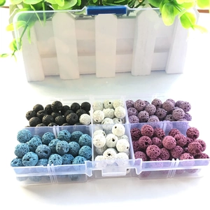 Detailed close-up of multi-colored porous lava stone beads organized in a plastic grid box