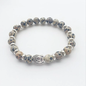 Macro shot of Dalmatian Jasper beads with silver Buddha head and disk spacers