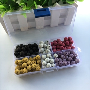 Detailed view of multi-colored lava stone beads in a clear plastic organizer box