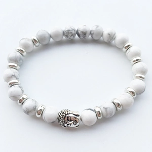 Detailed close-up of white howlite beads and silver Buddha head on elastic bracelet
