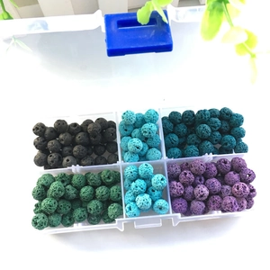 Detailed top view of natural multi-color lava stone beads in a 10-grid storage box