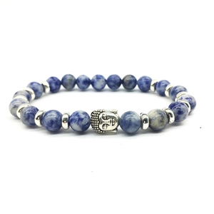 Blue volcanic stone beaded bracelet with silver Buddha head charm on white background