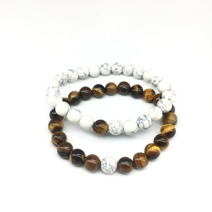 Detail of couple bracelet set with natural tiger eye and white turquoise stone beads