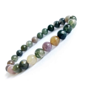 Macro detail of natural indian moss agate beads showing unique texture and colorful patterns