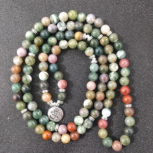 108 natural Indian agate beads bracelet with silver Om charm on dark textured background