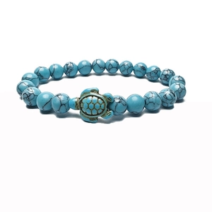 Detail of blue turquoise beaded bracelet with central sea turtle charm and gold accents