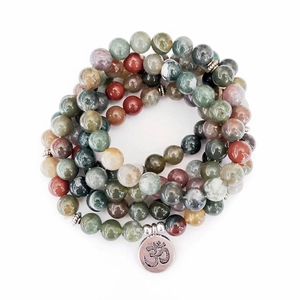 Close-up of 108 Indian agate beads with a metallic Om charm on a multi-layer bracelet