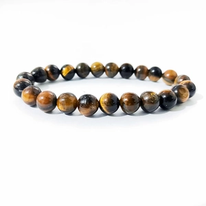 Macro view of 8mm tiger eye stone beads showing natural golden brown texture and luster