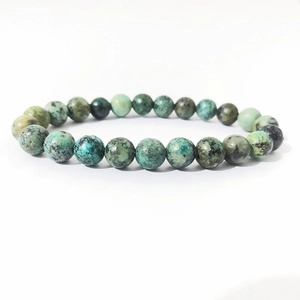 Macro shot of 8mm African turquoise beads with natural green and blue textures