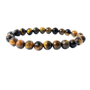 Macro detail of 8mm tiger eye stone beads with polished brown fiber textures