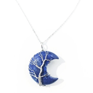 Detailed wire-wrapped Tree of Life design on blue crystal crescent moon pendant