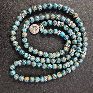 Blue malachite 108-bead prayer bracelet with silver lotus charm and floral spacers