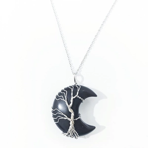 Detail of silver wire-wrapped Tree of Life on black obsidian moon-shaped pendant