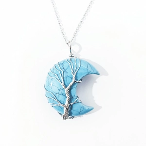 Natural light blue crescent moon crystal pendant with silver wire-wrapped tree of life