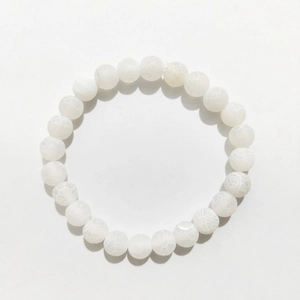 Macro detail of 8mm white cracked agate beads with natural ice texture on elastic bracelet
