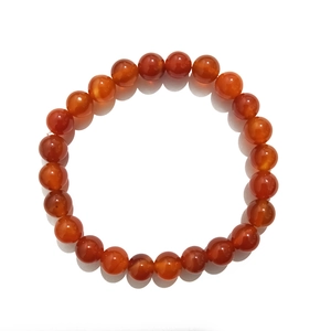 Macro detail of 8mm red agate beads bracelet with smooth polished natural crystal surface